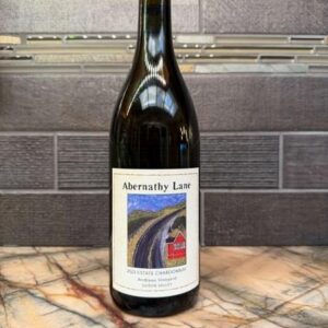 Bottle of Abernathy Lane 2023 Estate Chardonnay on a marble counter