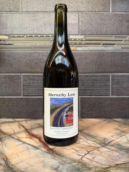 Bottle of Abernathy Lane 2023 Estate Chardonnay on a marble counter