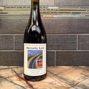 Bottle of Abernathy Lane 2023 Estate Grenache on a marble counter